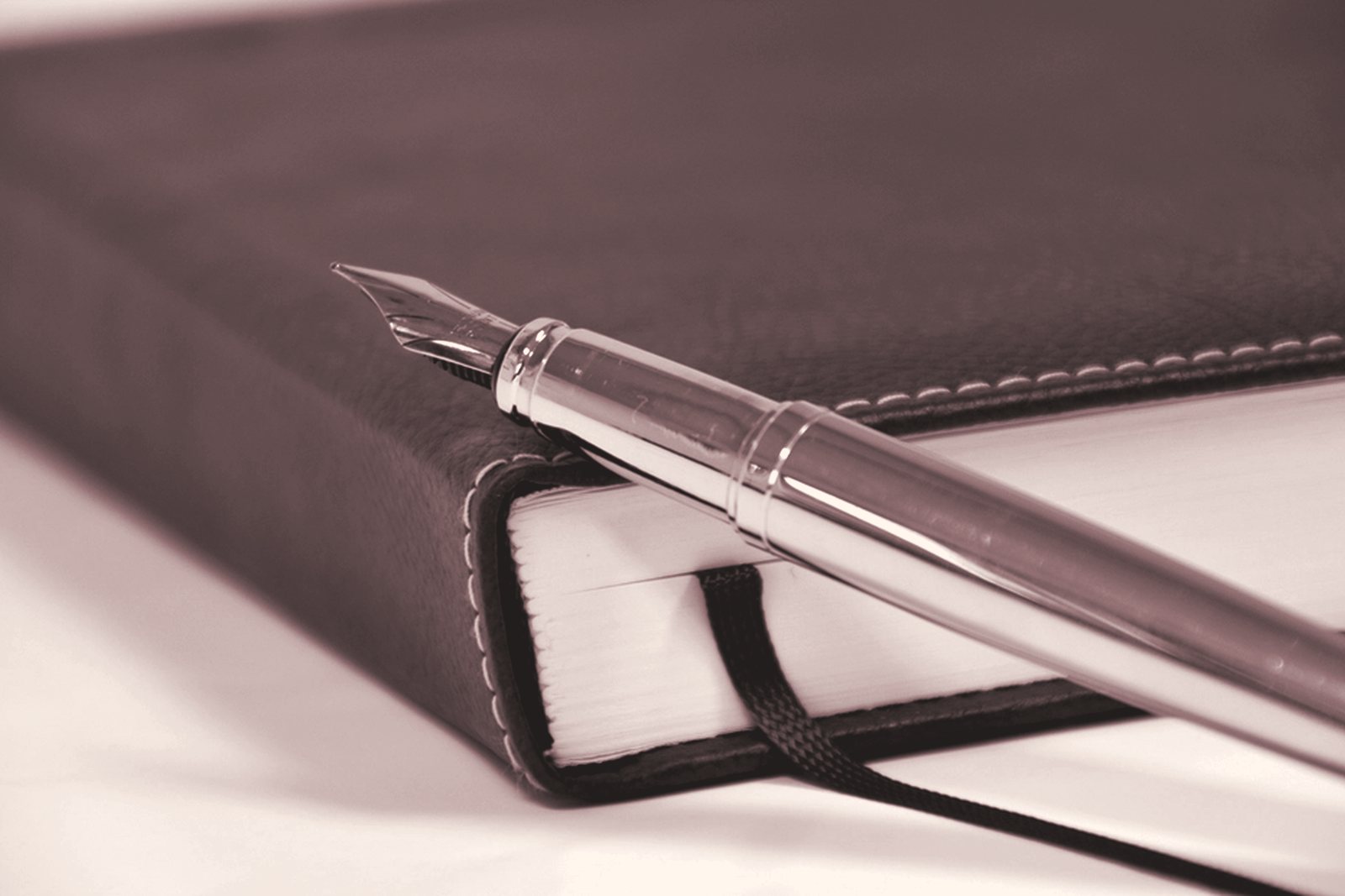 A fountain pen on a notebook