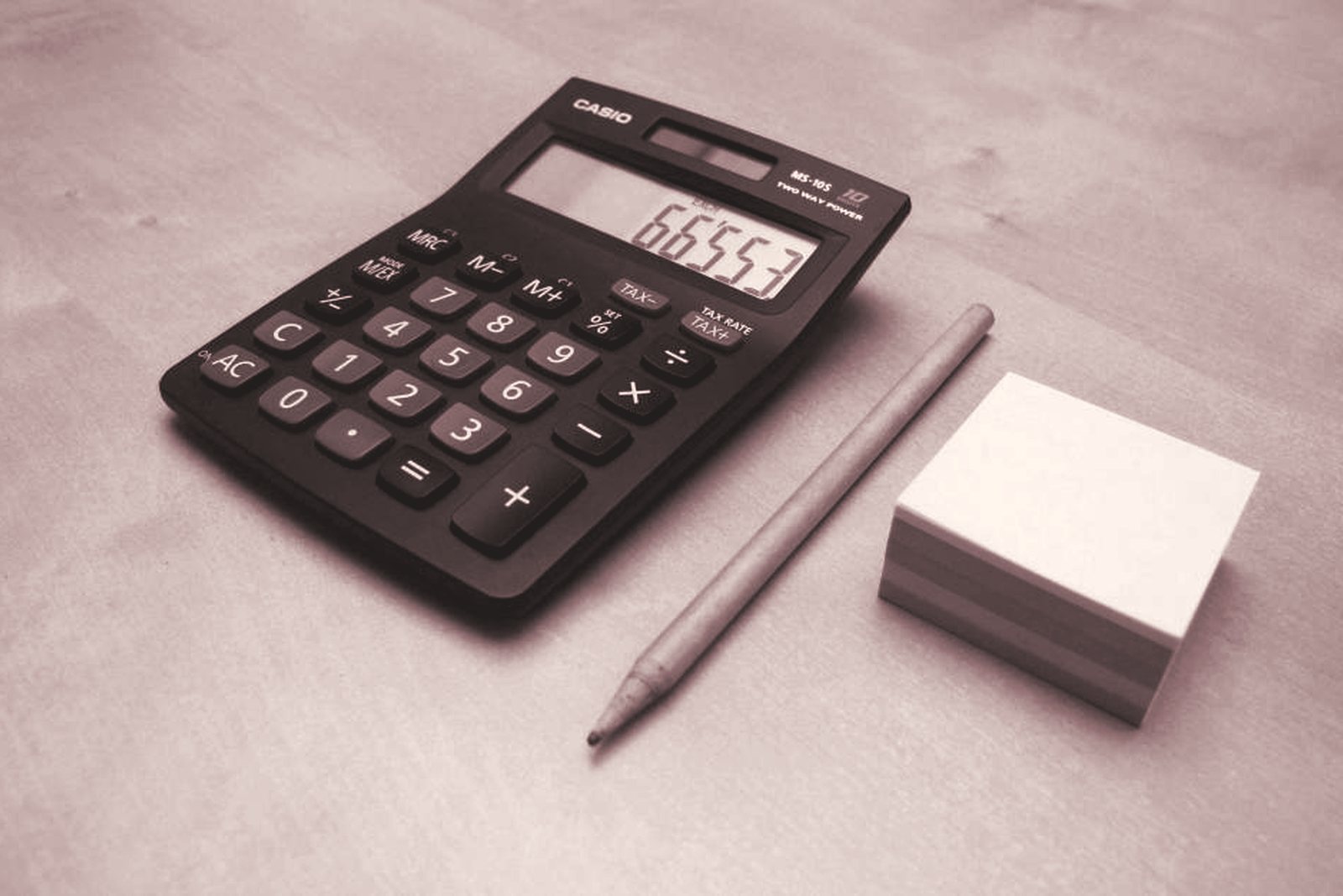 A calculator, a pencil and sticky notes